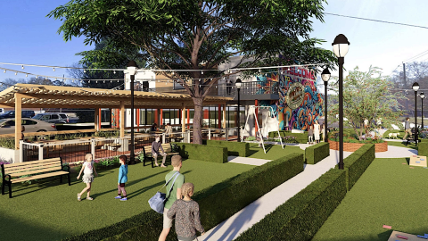 An image of a new market space with many tables and lawn spaces built from an old building along two wide streets in Avondale Estates Georgia.