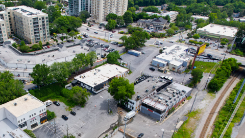 An overview image of a large development site near active railroad and Peachtree Road in Atlanta with many buildings and parking lots dotted around it, where a multi-use trail is planned.