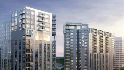 An image showing a site for a large two-tower high-rise project under blue-gray skies outside Atlanta near a major league baseball park.