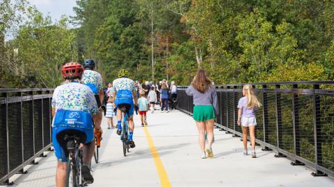 A photo of a new trail system with parks beside it near many towering trees north of Atlanta in Buckhead.