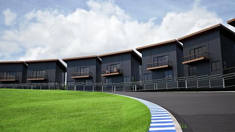 A rendering of a long row of black townhomes under blue skies at the edge of a large racetrack near forests north of Atlanta.