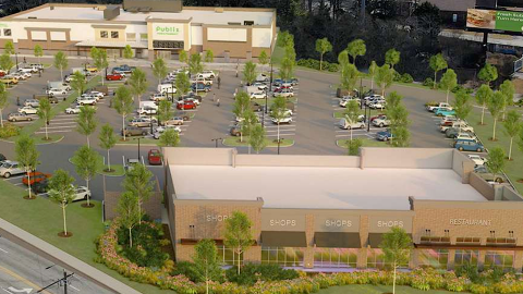 Overview of a large site where a shopping center is planned with a huge parking lot in the middle and a retail outbuilding near two wide streets.