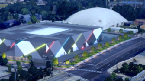 An image of a large silver and gray substation project in Atlanta near a wide street and many trees, under a blue evening sky with a white inflated dome next door.