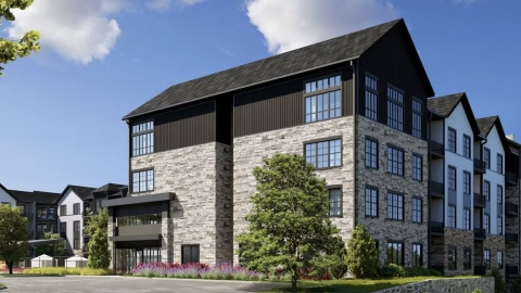 An image of a large planned development with pointed roofs under blue skies near a parking lot north of Atlanta.