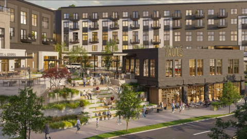 An overview of a large development with a green plaza at its core in Sandy Springs north of Atlanta near two wide streets.