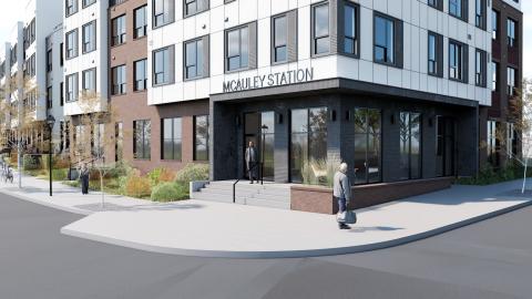A rendering showing a four-story apartment building under gray-blue skies near two wide streets in downtown Atlanta.