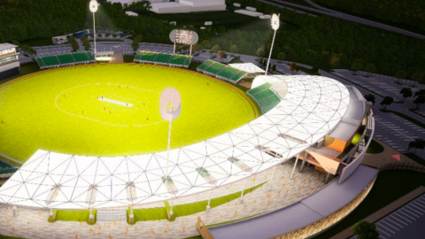 A rendering for a large new cricket stadium with a huge green pitch outside Atlanta near huge parking lots.