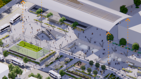 A rendering of a large train station in the middle of Atlanta with the top peeled off and many platforms and a soccer pitch beneath.