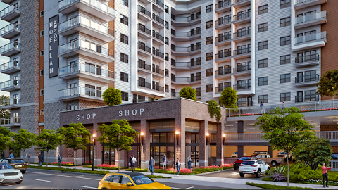 A photo of a large development site with a brick and stucco tower with many balconies and space for shops at the base just south of downtown Atlanta.