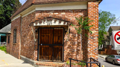 A small brick building under blue skies where two streets diverge, to be remade into offices in Atlanta.
