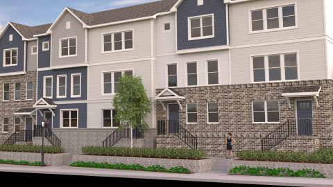 A large brown and brick and blue townhome project under blue skies in the City of Hapeville south of Atlanta.