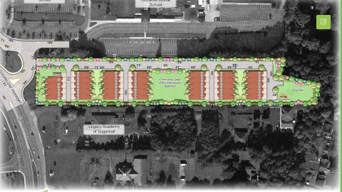 An image of a large townhome project near a wide roadway and many tree and buildings northeast of Atlanta in Gwinnett.