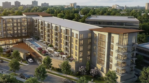 an image of a site where a large new condo building with beige walls and glass and many balconies is planned in northwest Atlanta.