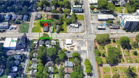 An overview of an old dilapidated church site in Atlanta near a huge cemetery where a renovation is underway.