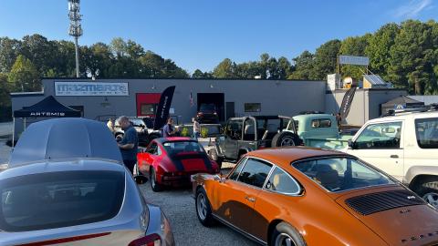 A photo of a large car storage showroom and lounge in an industrial style building with many nice cars near Atlanta.
