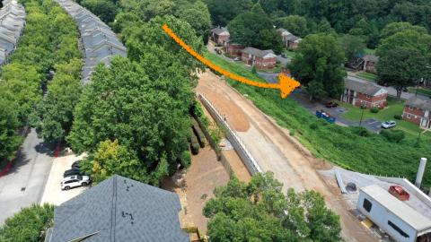 An aerial image of a large community of brick housing near many trees and a new Beltline trail section in Atlanta.