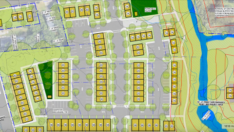 An overview of a large vacant site in Westside Atlanta where 90 homes are planned near a stream and many trees, next to two wide streets. 