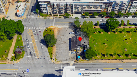 A photo of a corner barbecue property in Atlanta between two busy roads and surrounded by parks and buildings.