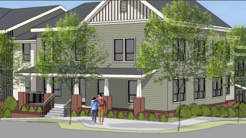 A rendering of a large new affordable housing complex that looks like homes on a corner under blue skies in Kirkwood Atlanta. 