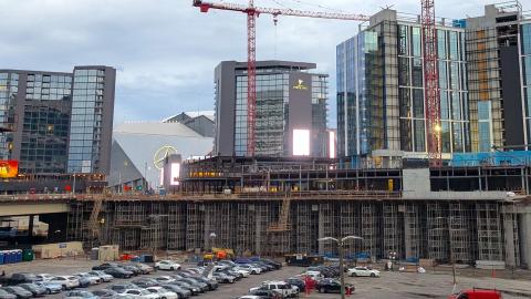 A photo of a massive construction site with several glassy and new towers near two stadiums in downtown Atlanta.