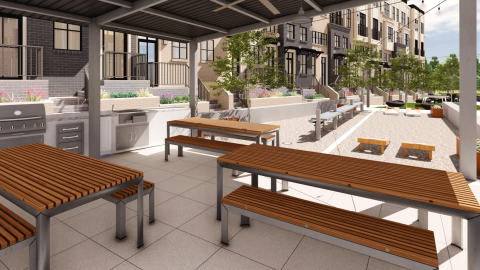 An image of a large row of modern-style townhomes and condos with brick and stucco facades on a wide street near Atlanta.