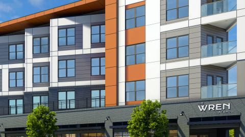 A rendering showing a large orange, gray, and white apartment infill project under blue skies over two wide Atlanta streets, now under construction.
