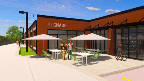 An image of a site for a new warehouse building redo next to the Beltline trail along a segment near a busy roadway in Atlanta near a brewery. 