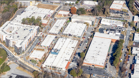 An overview of a large warehouse district west of Midtown Atlanta with many white roofs and streets. 