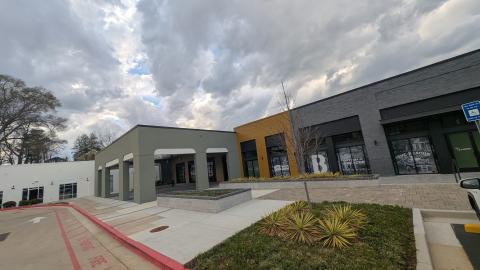An image of a large former warehouse district under gray-blue skies in Atlanta with many vacant storefronts right now.