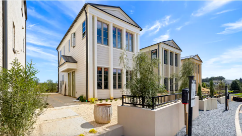 An image of a cottage style house with modern interiors under blue skies near a large park in a community called Trilith south of Atlanta. 