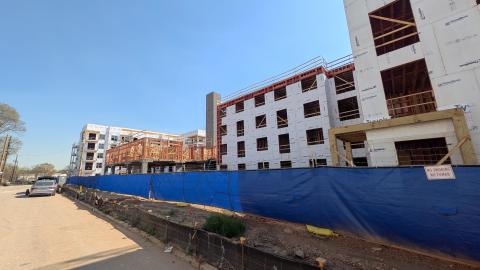 An image of a large new development in Atlanta under blue skies with wide streets and a long walking trail nearby