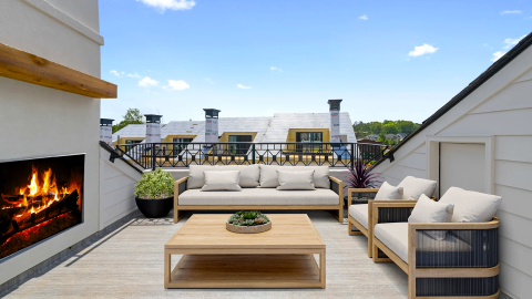 A photo of a large new townhome with white brick exteriors and modern-style interiors in Alpharetta, north of Atlanta.