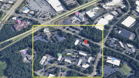 An overview of two office parks near many wide roads and trees in north metro Atlanta, where mixed-use development is planned.