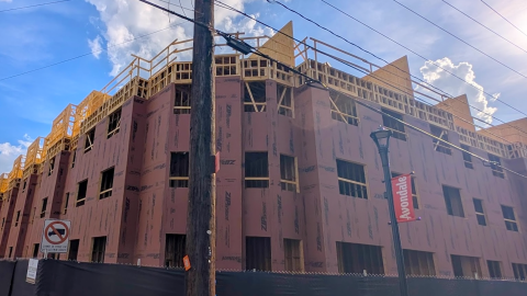 An image showing a site where a large new apartment community is rising up along a highway east of Atlanta.