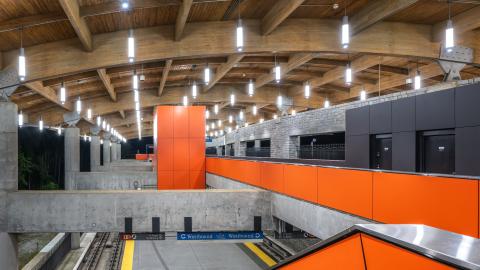 An image showing a large updated train station east of Atlanta with large orange panels and a barrel roof. 