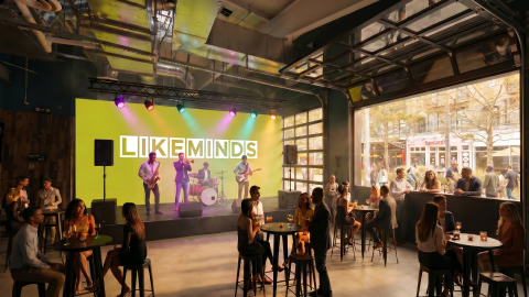 An image of a massive former warehouse space along the Atlanta Beltline with many new games and people at tables drinking beer.