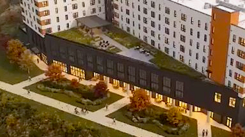 An image of a new building along a wide concrete pathway in Atlanta near many green areas.