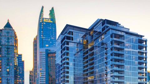 An image of a large new tower project in Atlanta in the shadow of many skycrapers.