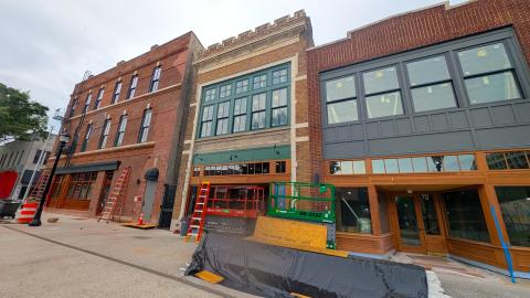 A photo of a row of old buildings with many renovations ongoing just south of downtown Atlanta high-rises. 