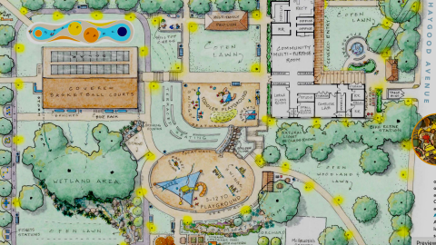 An image of a large park space in Atlanta with new lawns and gardens and playgrounds, along with trees near wide streets.