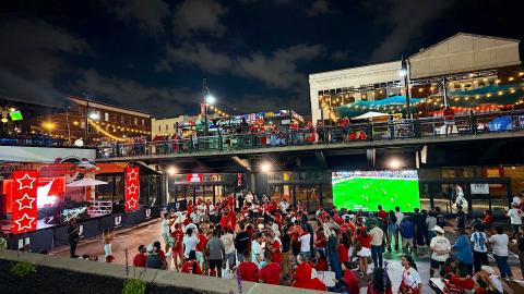 An image of the Underground Atlanta district in downtown surrounded by many buildings with a large screen for soccer near a big stage.