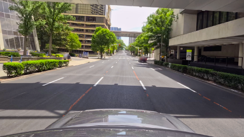 An image of a new data program that's cutting back on downtown potholes near many trees and buildings.