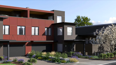 An image of a corner under blue skies in Atlanta near many trees where two duplexes are under construction now. 