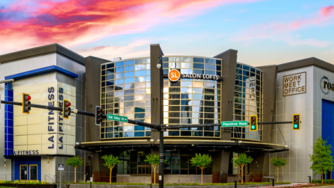 An image of a renovated shopping center block in Buckhead in Atlanta with wide walkways under blue skies.