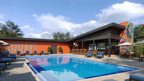 An image of a large pool and amenities area at a townhome community in Atlanta near many trees and streets.