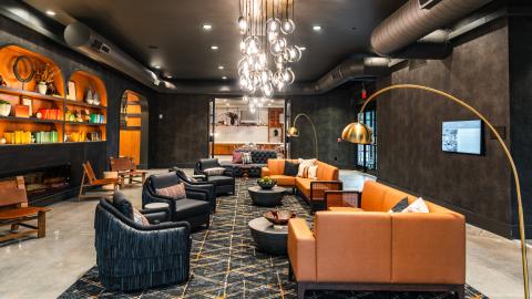 An image of a brick hotel on a corner of downtown Lawrenceville GA on a corner with modern-style interiors and restaurant areas.