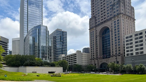 An image of a large open greenspace in the middle of Midtown Atlanta where a park is planned with many towers around it.