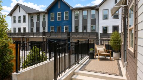 An image of a large new townhome project with many colored facades and white modern interiors in southwest Atlanta.
