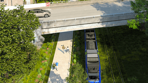 An image of a new train system on the Atlanta Beltline loop with many stations and blue train cars and bridges near trees and streets. 