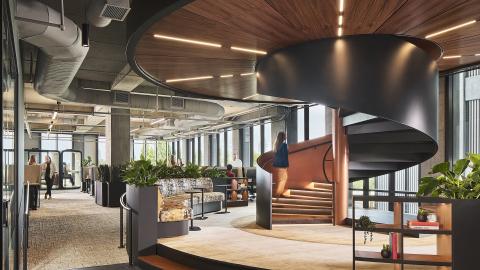 An image of a modern new office space with lab areas and many desks and modern design, with skyline views to Atlanta in the distance.